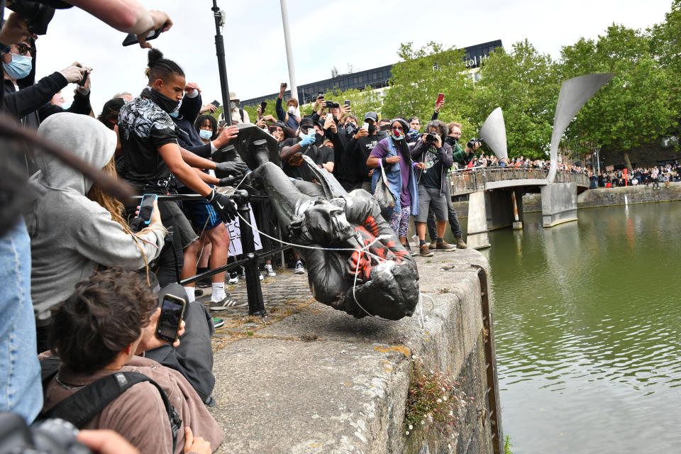 Protesters throw statue of Edward Colston into Bristol harbour during a Black Lives Matter protest rally, in memory of George Floyd who was killed on May 25 while in police custody in the US city of Minneapolis.