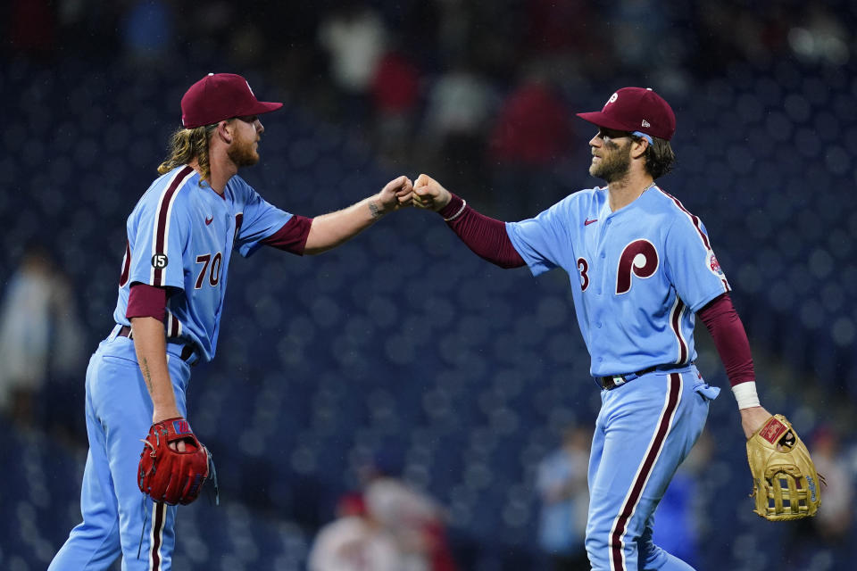 Philadelphia Phillies' Bryce Harper, right, and Bailey Falter celebrate after a baseball game against the Pittsburgh Pirates, Thursday, Sept. 23, 2021, in Philadelphia. (AP Photo/Matt Slocum)