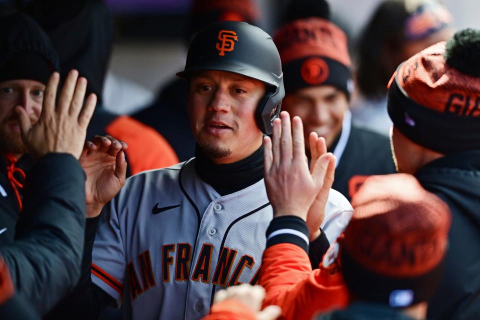 San Francisco Giants' Thairo Estrada is congratulated in the dugout after hitting a two run home run off Cleveland Guardians starting pitcher Aaron Civale in the second inning of a baseball game, Sunday, April 17, 2022, in Cleveland. (AP Photo/David Dermer)
