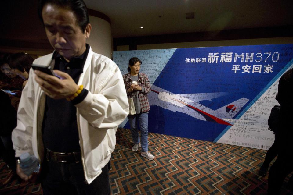 Relatives of Chinese passengers on board the missing Malaysia Airlines 370 wait in a room after walking out to protest the difficulties of communicating with Malaysian officials through video conferencing in Beijing, China, Wednesday, April 16, 2014. A robotic submarine looking for the lost Malaysian jet continued its second seabed search on Wednesday as up to 14 planes were to take to the skies for some of the final sweeps of the Indian Ocean for floating debris from the ill-fated airliner. (AP Photo/Ng Han Guan)