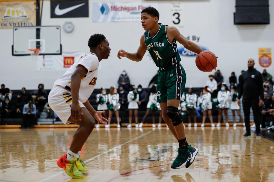 Detroit Cass Tech's Darius Acuff (11) dribbles against Detroit King's Terrance Brown Jr. (4)  during the first half at Martin Luther King Jr. Senior High School in Detroit on Friday, Jan. 21, 2022.