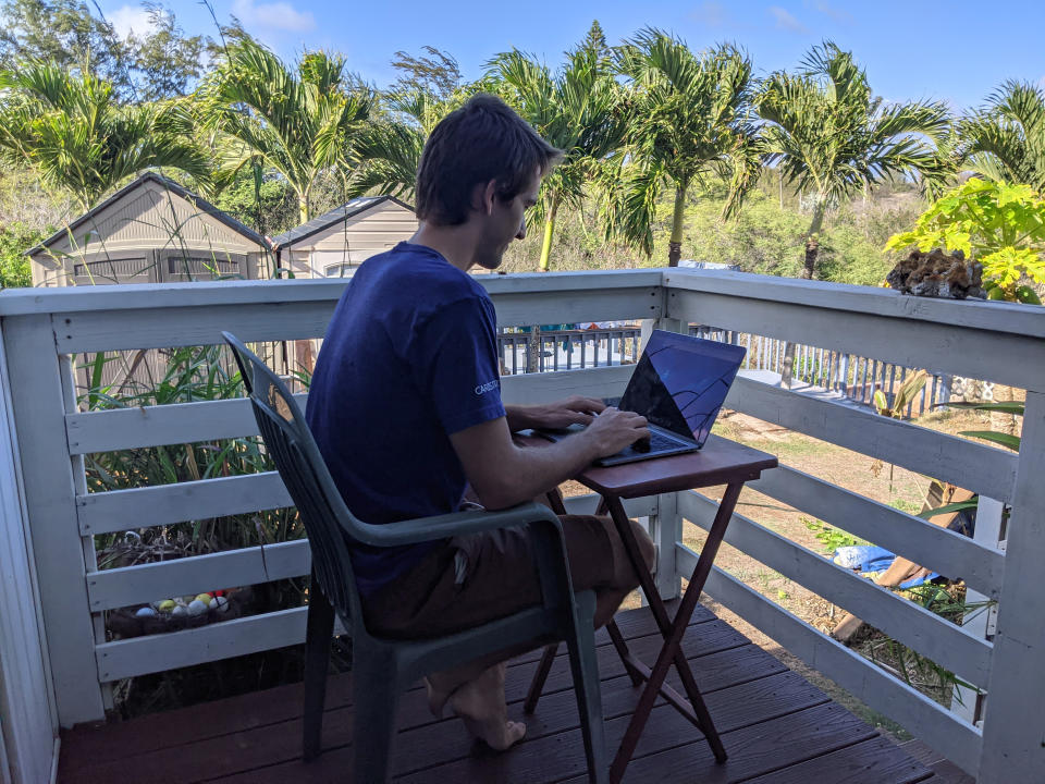 In this photo provided by Marley C. Alford, Raymond Berger, a New York City software engineer, works remotely on Nov. 22, 2020, in Kahului, Hawaii. A group of Hawaii leaders is trying to attract people like Berger to work remotely from Hawaii during the pandemic. (Marley C. Alford via AP)