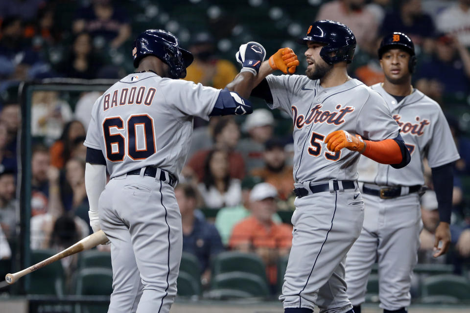 Detroit Tigers' Akil Baddoo (60) and Renato Nunez (55) celebrate Nunez's two-run home run as Jonathan Schoop, right, looks on during the fourth inning of the team's baseball game against the Houston Astros on Tuesday, April 13, 2021, in Houston. (AP Photo/Michael Wyke)