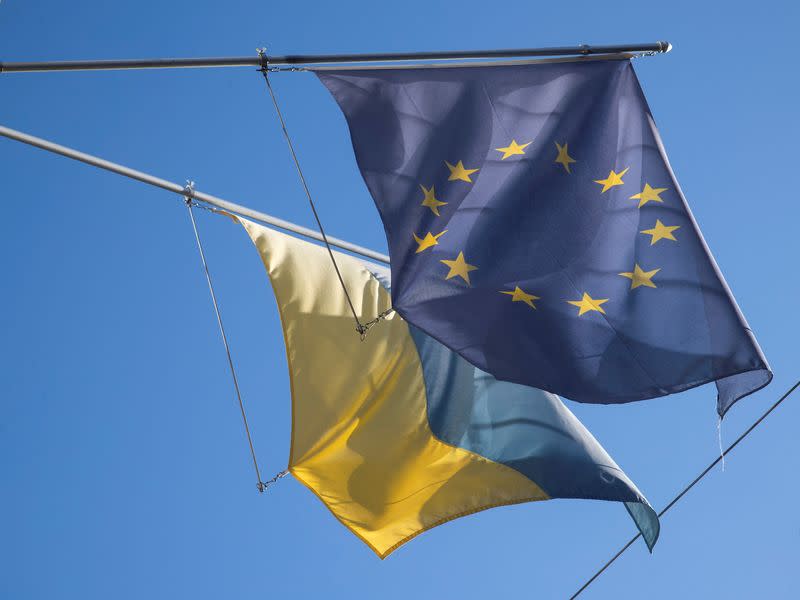 FILE PHOTO: Flag of EU flies next to Ukraine's national flag in Bern