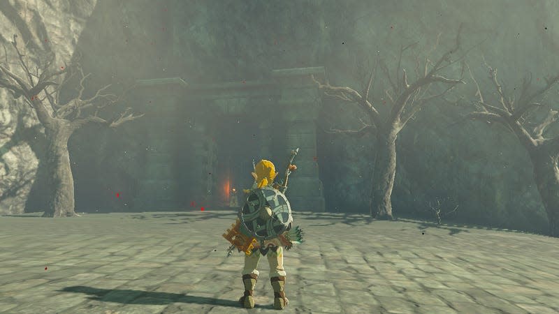 Link stands before a doorway.