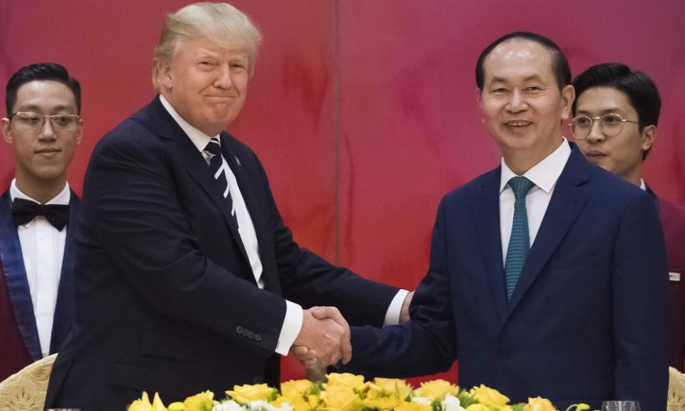 Vietnamese President Tran Dai Quang shakes hands with Donald Trump in Hanoi.