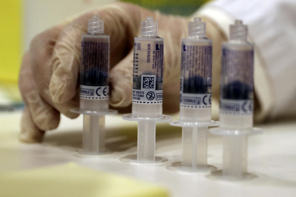 A medic prepares syringes of the Pfizer-BioNTech COVID-19 vaccine during a nationwide vaccination campaign, at the American University Medical Center in Beirut, Lebanon, Sunday, Feb. 14, 2021. (AP Photo/Bilal Hussein)