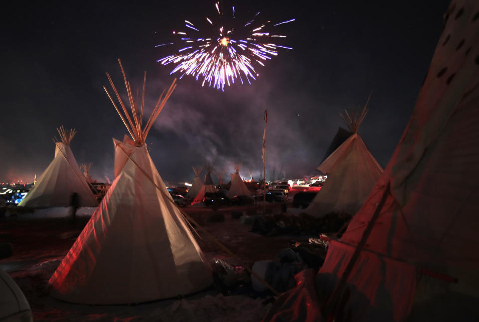 Fireworks fill the night sky above Oceti Sakowin Camp as activists celebrate after learning an easement had been denied for the Dakota Access Pipeline near the edge of the Standing Rock Sioux Reservation. (Photo: Scott Olson/Getty Images)