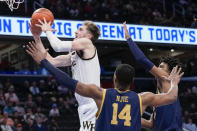 Wake Forest forward Andrew Carr shoots in front of Notre Dame forwards Kebba Njie and Carey Booth during the first half of an NCAA college basketball game in the second round of the Atlantic Coast Conference tournament, Wednesday, March 13, 2024, in Washington. (AP Photo/Susan Walsh)
