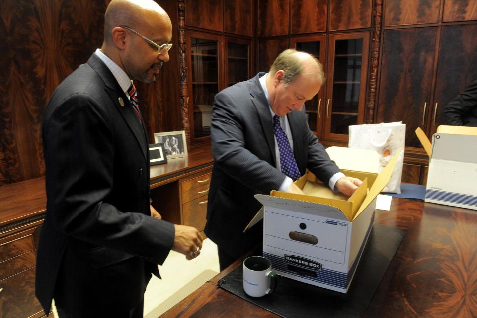 New Detroit Mayor Mike Duggan unpacks boxes with Melvin "Butch" Hollowell after taking the oath of office, New Years Day, Wednesday, Jan. 1, 2014, at the Coleman Young Municipal Center in Detroit. (AP Photo/The Detroit News, Steve Perez)