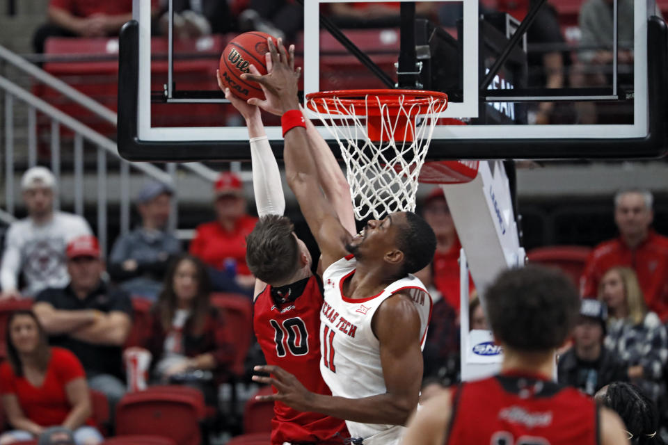 Texas Tech's Bryson Williams (11) blocks the shot by Eastern Washington's Ethan Price (10) during the first half of an NCAA college basketball game on Wednesday, Dec. 22, 2021, in Lubbock, Texas. (AP Photo/Brad Tollefson)