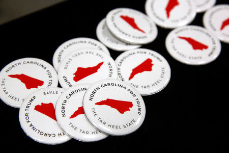 North Carolina campaign buttons sit on a table before the start of a rally with Republican U.S. presidential nominee Donald Trump in Fletcher, North Carolina, U.S. October 21, 2016. REUTERS/Jonathan Ernst