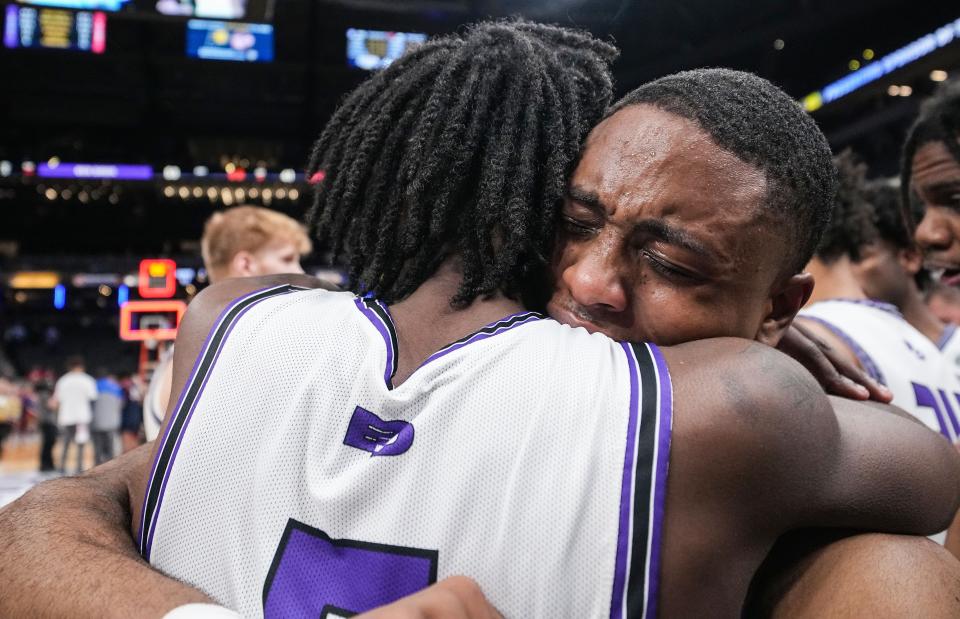 Ben Davis Giants Clay Butler III (13) hugs Ben Davis Giants Sheridan Sharp (5) on Saturday, March 25, 2023 at Gainbridge Fieldhouse in Indianapolis. The Ben Davis Giants defeated the Kokomo Wildkats, 53-41, for the IHSAA Class 4A state finals championship. 