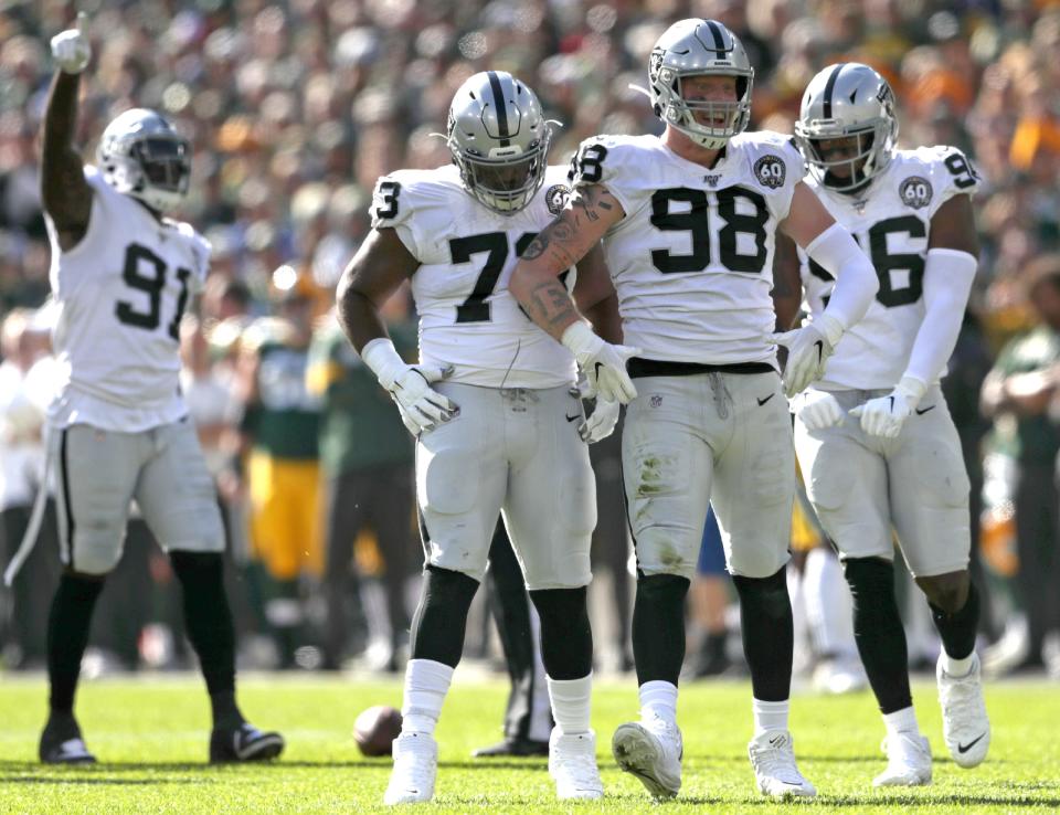 Oakland Raiders defensive end Maxx Crosby (98) celebrates after sacking Green Bay Packers quarterback Aaron Rodgers (12) during their football game on Oct. 20, 2019, at Lambeau Field in Green Bay.