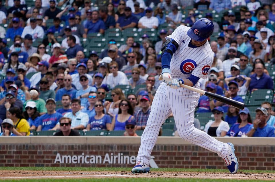 Chicago Cubs left fielder Ian Happ (8) hits a two run double against the Pittsburgh Pirates during the first inning at Wrigley Field on July 26, 2022.