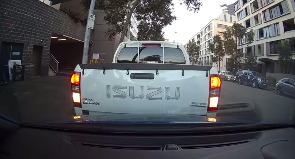 A ute driven by two City of Sydney parking inspectors backs into a car while parking.