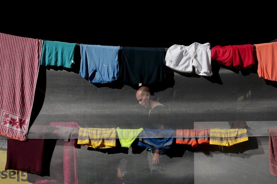 A Cuban migrant is seen among drying clothes as he waits for the opening of the border between Costa Rica and Nicaragua in Penas Blancas, Costa Rica November 17, 2015. More than a thousand Cuban migrants hoping to make it to the United States were stranded in the border town of Penas Blancas, Costa Rica, on Monday after Nicaragua closed its border on November 15, 2015 stoking diplomatic tensions over a growing wave of migrants making the journey north from the Caribbean island. REUTERS/Oswaldo Rivas