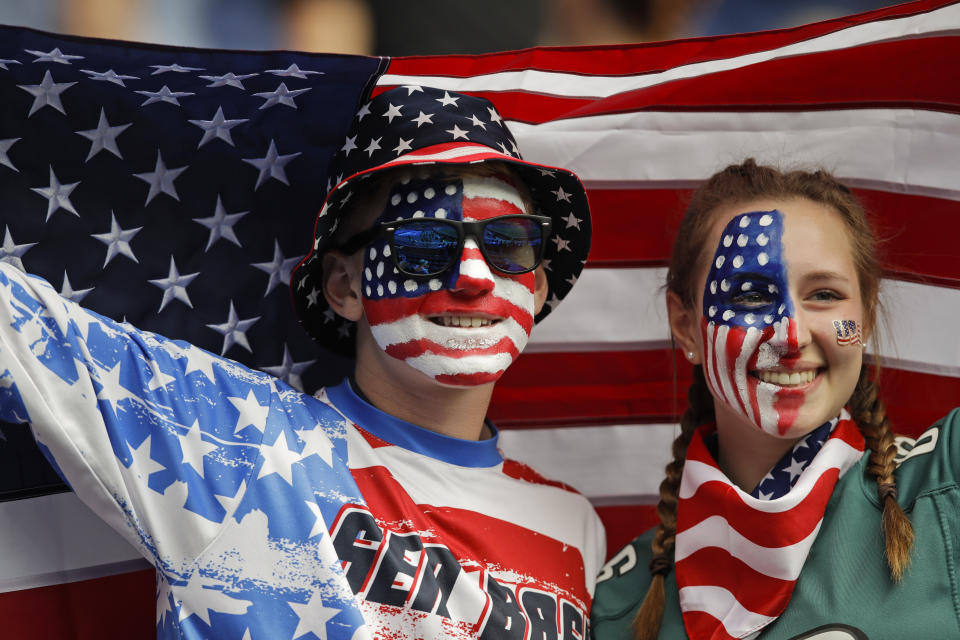 Brothers Austin, left, and Jordyn Chambers, from Philadelphia, hold up an US flag prior the Women's World Cup Group F soccer match between United States and Chile at Parc des Princes in Paris, France, Sunday, June 16, 2019. (AP Photo/Alessandra Tarantino)