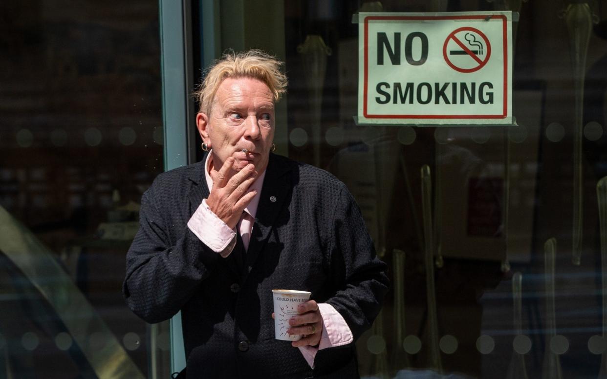 John Lydon, aka Johnny Rotten, smokes outside the Rolls Building at the High Court, London - Dominic Lipinski/PA Wire