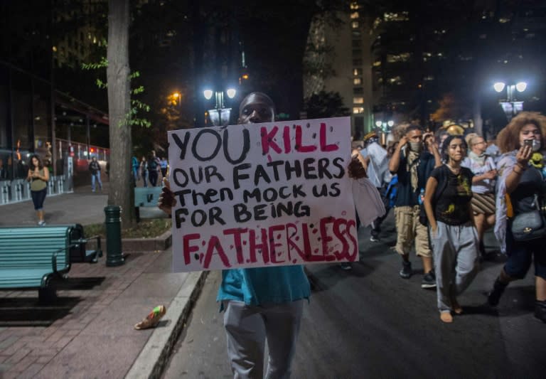 A protester holds a sign during a demonstration against police brutality in Charlotte, North Carolina