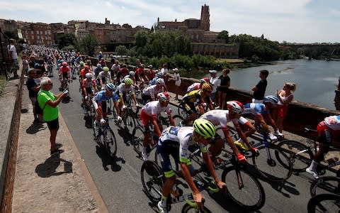 The peloton rolls out of Albi during the neutralised section of Wednesday's stage - Credit: REUTERS