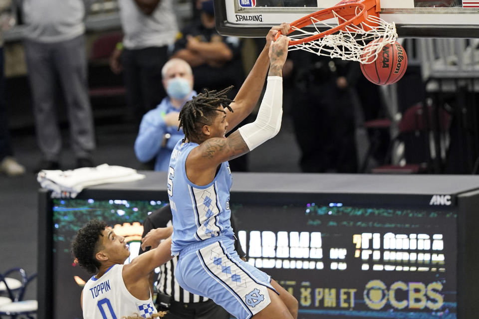 North Carolina's Armando Bacot (5) dunks the ball over Kentucky's Jacob Toppin (0) in the second half of an NCAA college basketball game, Saturday, Dec. 19, 2020, in Cleveland. North Carolina won 75-63. (AP Photo/Tony Dejak)