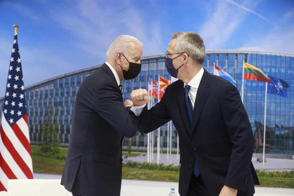 NATO Secretary General Jens Stoltenberg greets U.S. President Joe Biden with an elbow bump prior to a bilateral meeting on the sidelines of a NATO summit at NATO headquarters in Brussels, Monday, June 14, 2021. U.S. President Joe Biden is taking part in his first NATO summit, where the 30-nation alliance hopes to reaffirm its unity and discuss increasingly tense relations with China and Russia, as the organization pulls its troops out after 18 years in Afghanistan. (Stephanie Lecocq, Pool via AP)