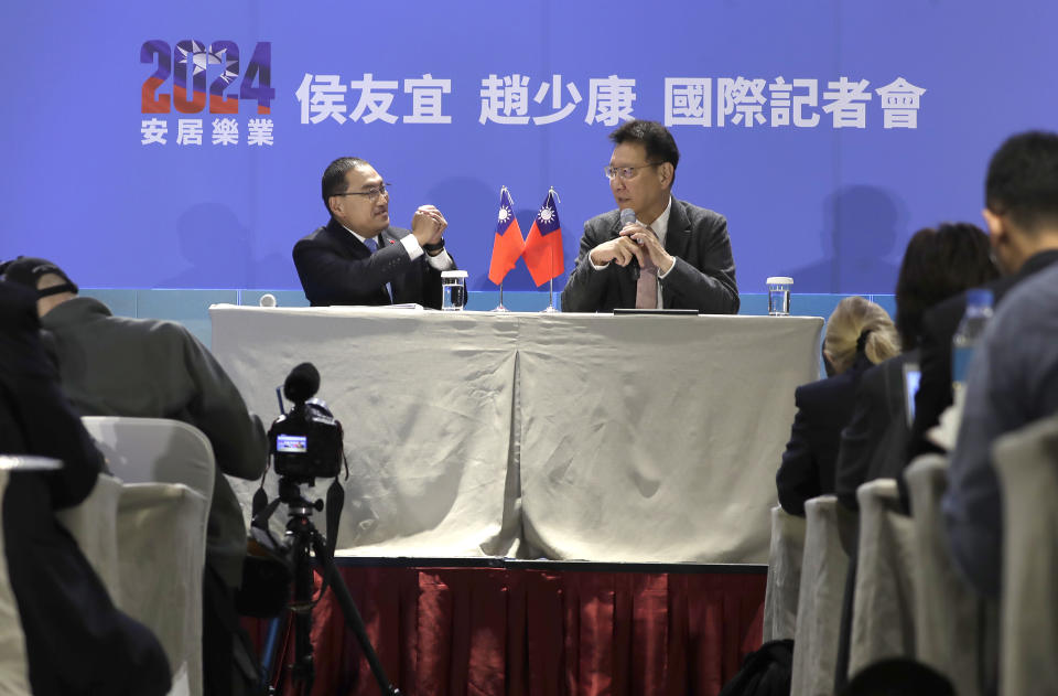 Taiwan's Nationalist Party presidential candidate Hou Yu-ih, left, interacts with his running mate Jaw Shau-kong during an international press conference in New Taipei, Taiwan, Thursday, Jan. 11, 2024. Taiwan will hold its presidential election on Jan. 13. (AP Photo/Chiang Ying-ying)