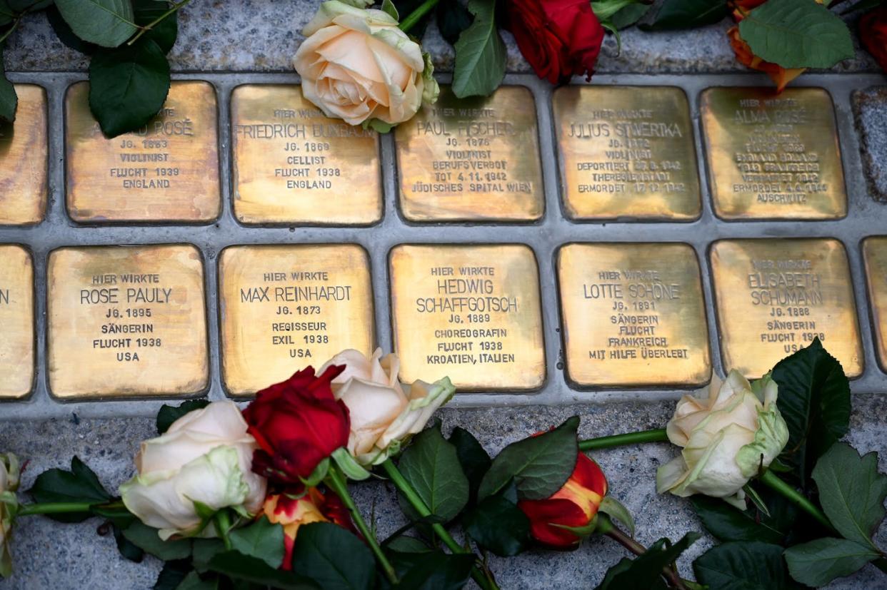 Plaques commemorating artists who were killed by the Nazis are marked with flowers in Austria in 2020. <a href="https://media.gettyimages.com/id/1228082555/photo/austria-germany-wwii-salzburg-festival-jews.jpg?s=612x612&w=gi&k=20&c=g-1Nlh7mzS7sqGVFsvNVnvzQneKWKGI7oQ-n6_zUHqg=" rel="nofollow noopener" target="_blank" data-ylk="slk:Barbara Gindl/APA/AFP via Getty Images;elm:context_link;itc:0;sec:content-canvas" class="link ">Barbara Gindl/APA/AFP via Getty Images </a>