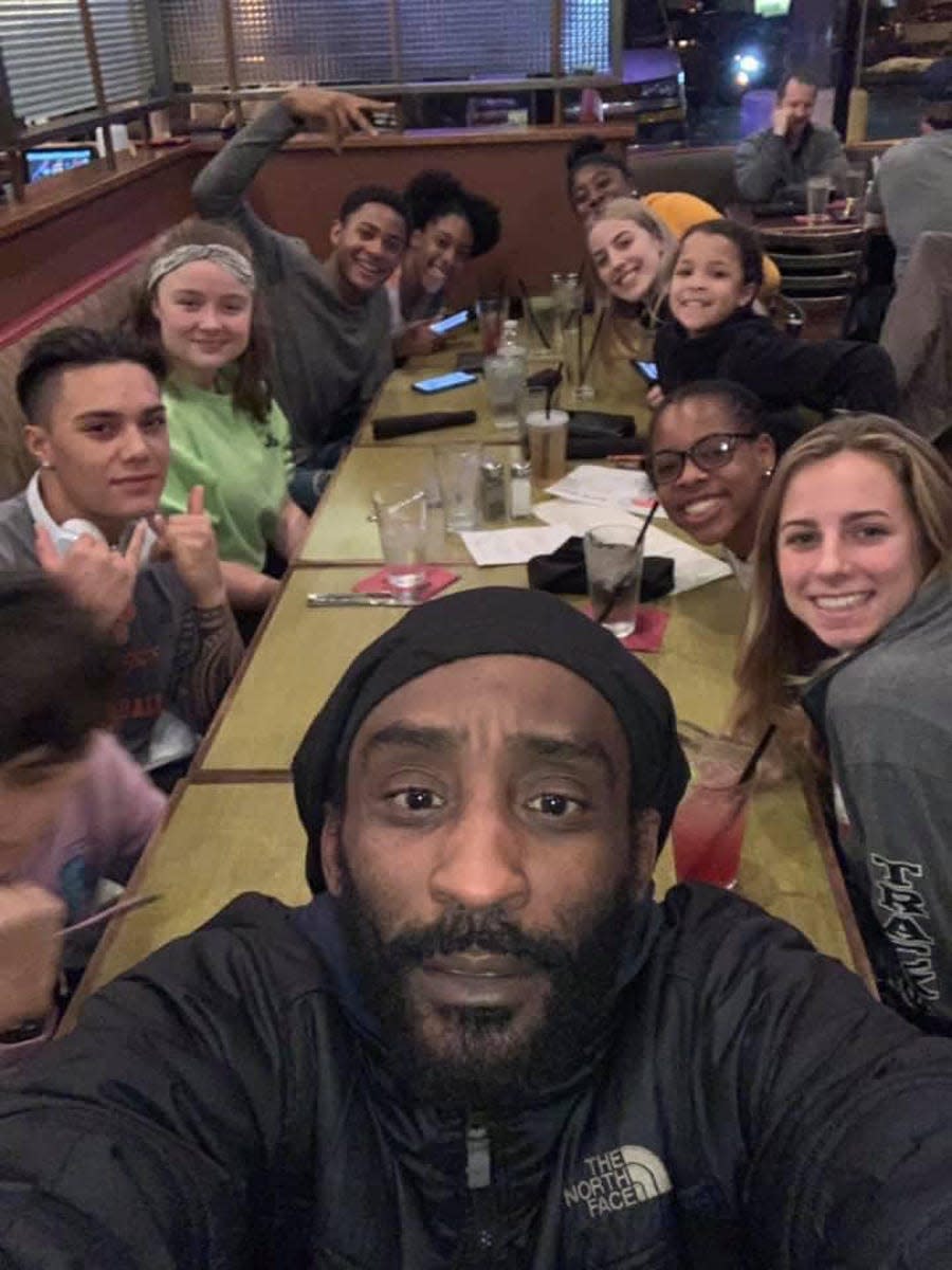 Ron Atkins takes a selfie with the Kitsap Fliers track and field club he founded several years ago with other area coaches.