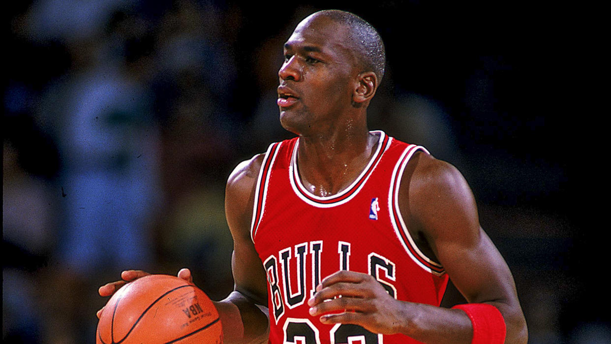 1990:  Michael Jordan #23 of the Chicago Bulls runs with the ball during the game.