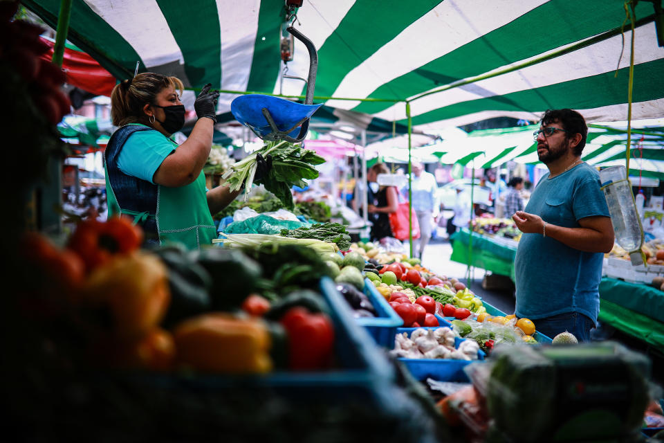 MEXICO CITY, MEXICO - APRIL 17: Rosa Mar’a attends  a customer at her mobile vegetable stand on April 17, 2020 in Mexico City, Mexico. Mexico is under health emergency, which implies that only essential activities are permitted. Government suggested population to stay at home but quarantine is not obligatory as there is major concern about the economic activity. Hugo Lopez-Gatell Undersecretary of Prevention and Health Promotion announced the extension of the measures until at least, May 30 in those cities with a bigger risk and number of contagion. (Photo by Manuel Velasquez/Getty Images)