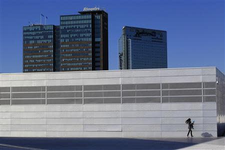 A woman carries her child on the roof of the Opera House in Oslo in this June 20, 2012 file photo. REUTERS/Cathal McNaughton/Files