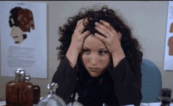 Elaine from Seinfeld holding her head and looking stressed