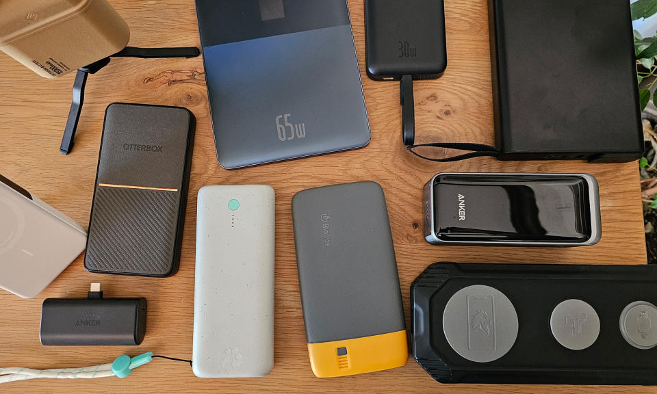 an assortment of power banks sit on a wooden table