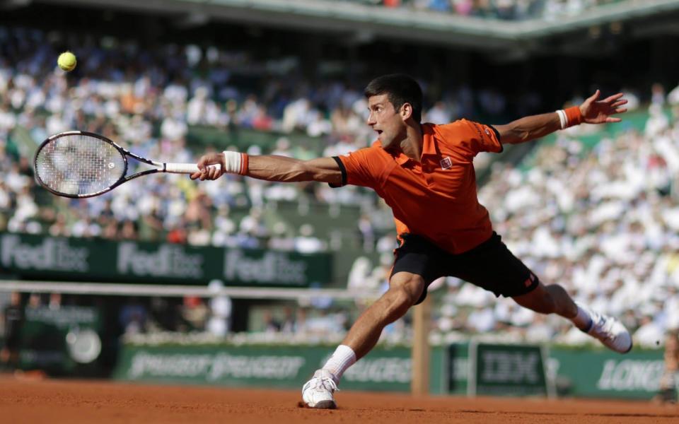 Serbia's Novak Djokovic hits a return to Great Britain's Andy Murray during their men's semi-final match of the Roland Garros 2015 French Tennis Open in Paris on June 5, 2015.  -  KENZO TRIBOUILLARD/AFP