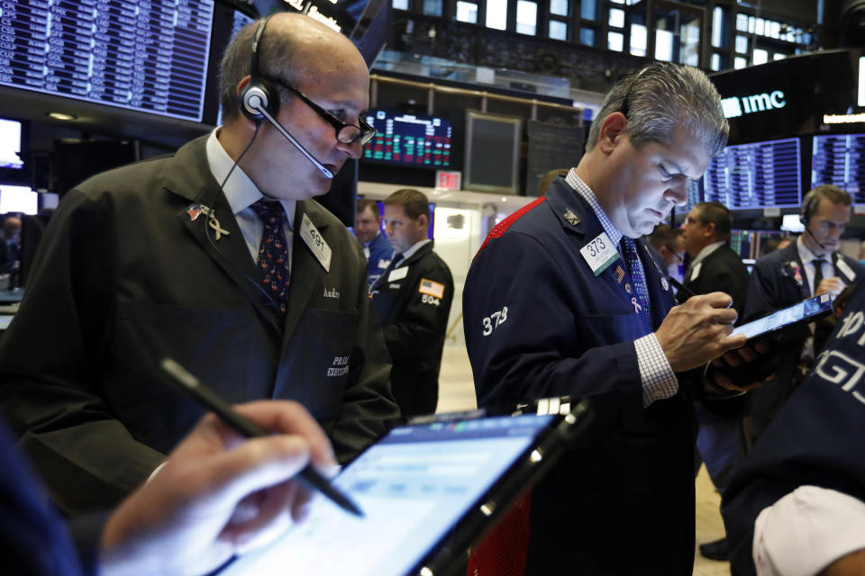 Traders Andrew Silverman, left, and John Panin work on the floor of the New York Stock Exchange, Wednesday, Sept. 4, 2019. Stocks are opening higher on Wall Street following big gains in Asia as Hong Kong's government withdrew a controversial extradition law that set off three months of protests there. (AP Photo/Richard Drew)