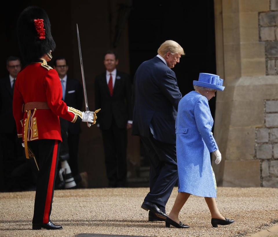 President Donald Trump with Queen Elizabeth II, as they walk out to begin to inspect the Guard of Honour at Windsor Castle in Windsor, England, Friday, July 13, 2018. (AP Photo/Pablo Martinez Monsivais)
