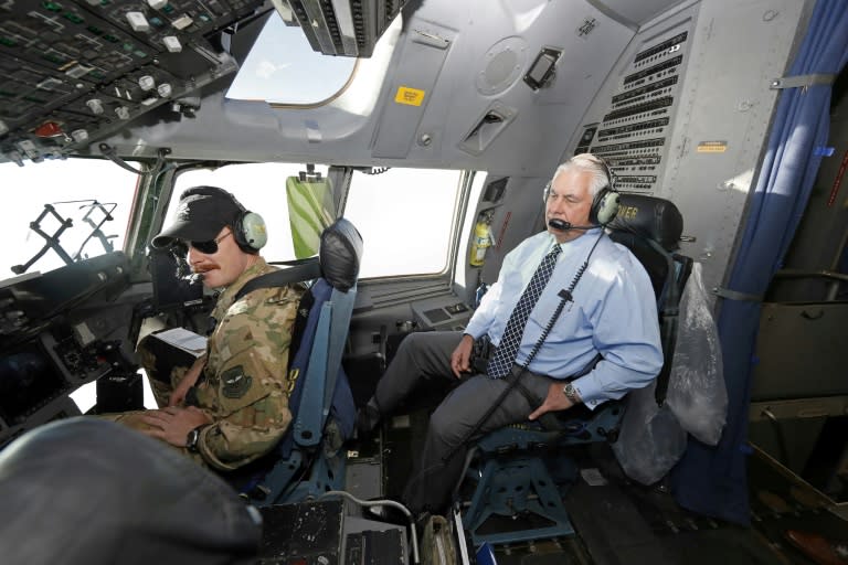 US Secretary of State Rex Tillerson talks with pilots as he sits in the cockpit of a C-17 aircraft while in flight to Bagram Air Base