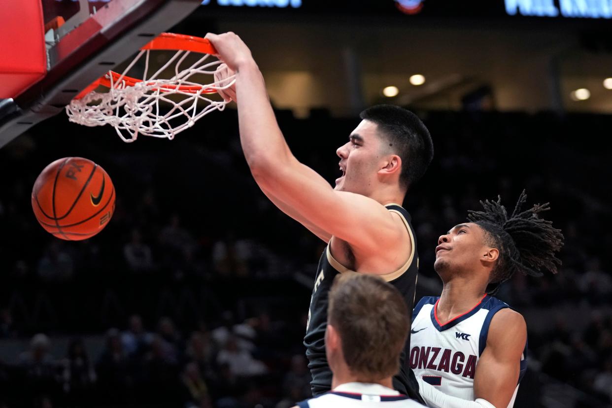 Purdue center Zach Edey dunks against Gonzaga guard Hunter Sallis, right, during the first half of an NCAA college basketball game in the Phil Knight Legacy tournament Friday, Nov. 25, 2022, in Portland, Ore. (AP Photo/Rick Bowmer)