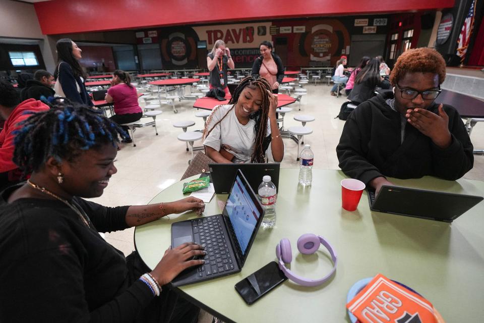 Seniors Maya Craft, Aleyia Fisher and Sean Powell learn about filling out college financial aid forms at a Travis Early College High School event this month. The Austin school district says some seniors who took a high school-level math class in the spring or summer of 2020 could see changes in their class rank this year due to a coding discrepancy.