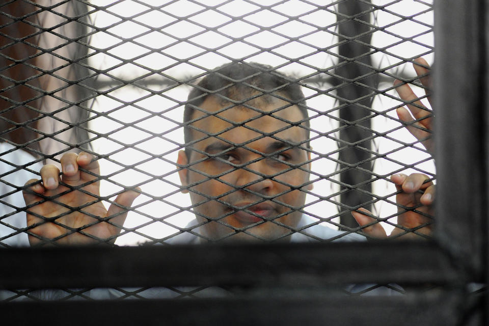 FILE - In this Wednesday, Dec. 4, 2013 file photo, Mohammed Badr, a cameraman for Al-Jazeera Mubasher Misr, appears at a court in Cairo, Egypt. Egypt’s chief prosecutor has referred 20 journalists who work for the Qatar-based Al-Jazeera network, including four foreigners, to a criminal trial on charges of joining or assisting a terrorist group and spreading false news that endangers national security. Egypt's interim-backed military government accuses the Qatar-based broadcaster of being biased in favor of the Muslim Brotherhood, which authorities have branded a terrorist organization. Only eight are currently in detention.(AP Photo/Ahmed Omar, File)