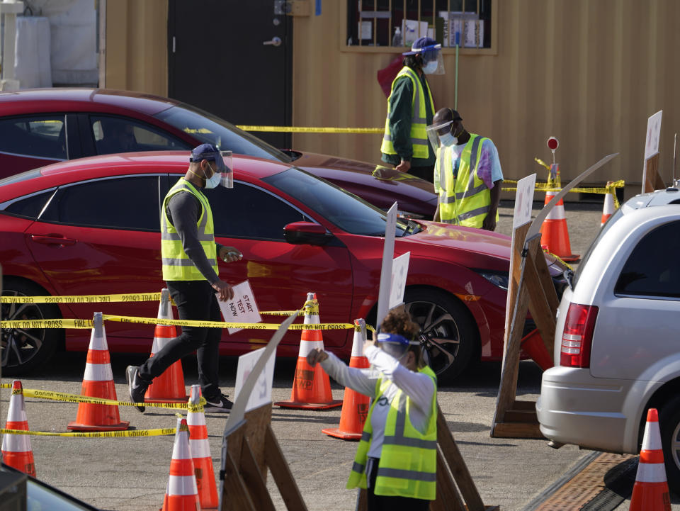 Motorists wait in line to take a coronavirus test in a parking lot at Dodger Stadium in Los Angeles on Thursday, Nov. 19, 2020. (AP Photo/Damian Dovarganes)