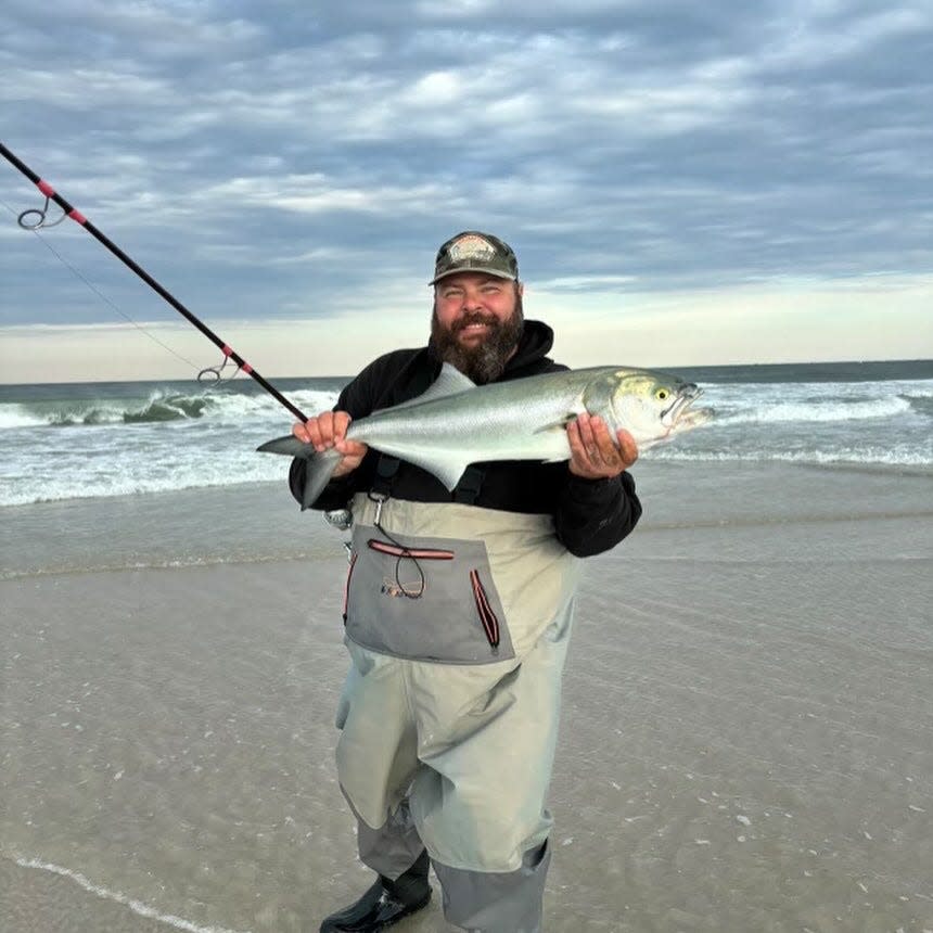 Scott Thomas holds up a bluefish he caught during the surf action this week along the Ocean County beaches.