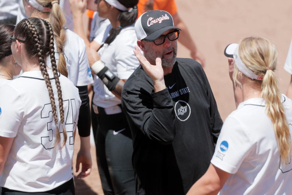 Oklahoma State coach Kenny Gajewski celebrates with pitcher Lexi Kilfoyl (8) after a softball game between the Oklahoma State Cowgirls and Kentucky in the Stillwater Regional of the NCAA Tournament, Saturday, May 18, 2024. Oklahoma State won 6-2.