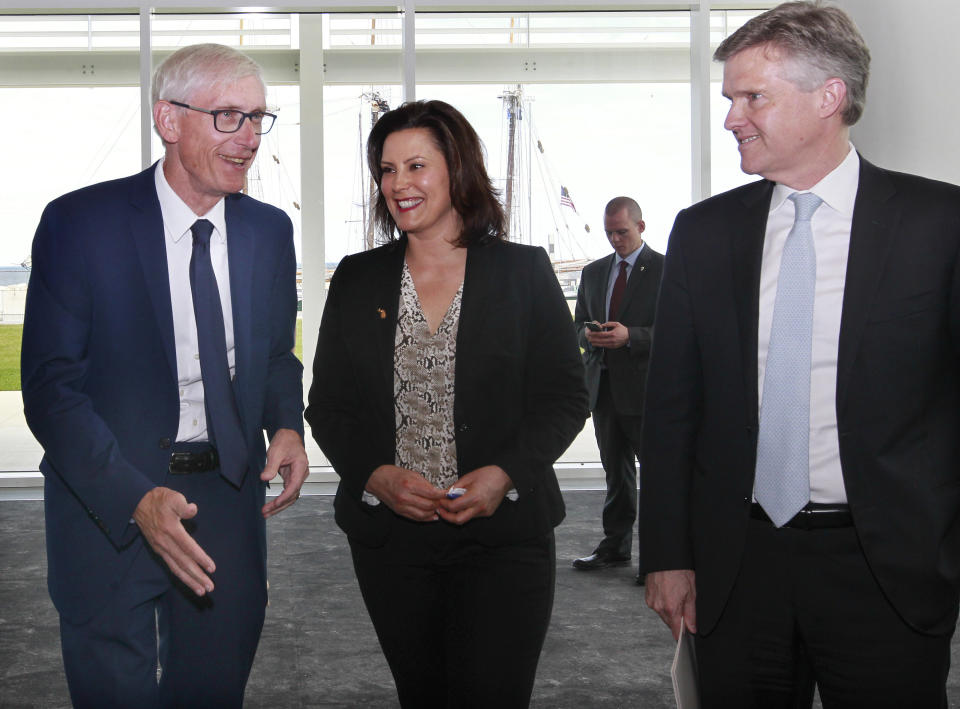 Wisconsin Gov. Tony Evers, left, Michigan Gov. Gretchen Whitmer and Ontario's Minister of the Environment, Conservation and Parks, Rod Phillips, leave a press conference after sharing highlights of their 2019 Leadership Summit at the Discovery World, Friday, June 14, 2019 in Milwaukee, Wis. (Angela Peterson/Milwaukee Journal-Sentinel via AP)