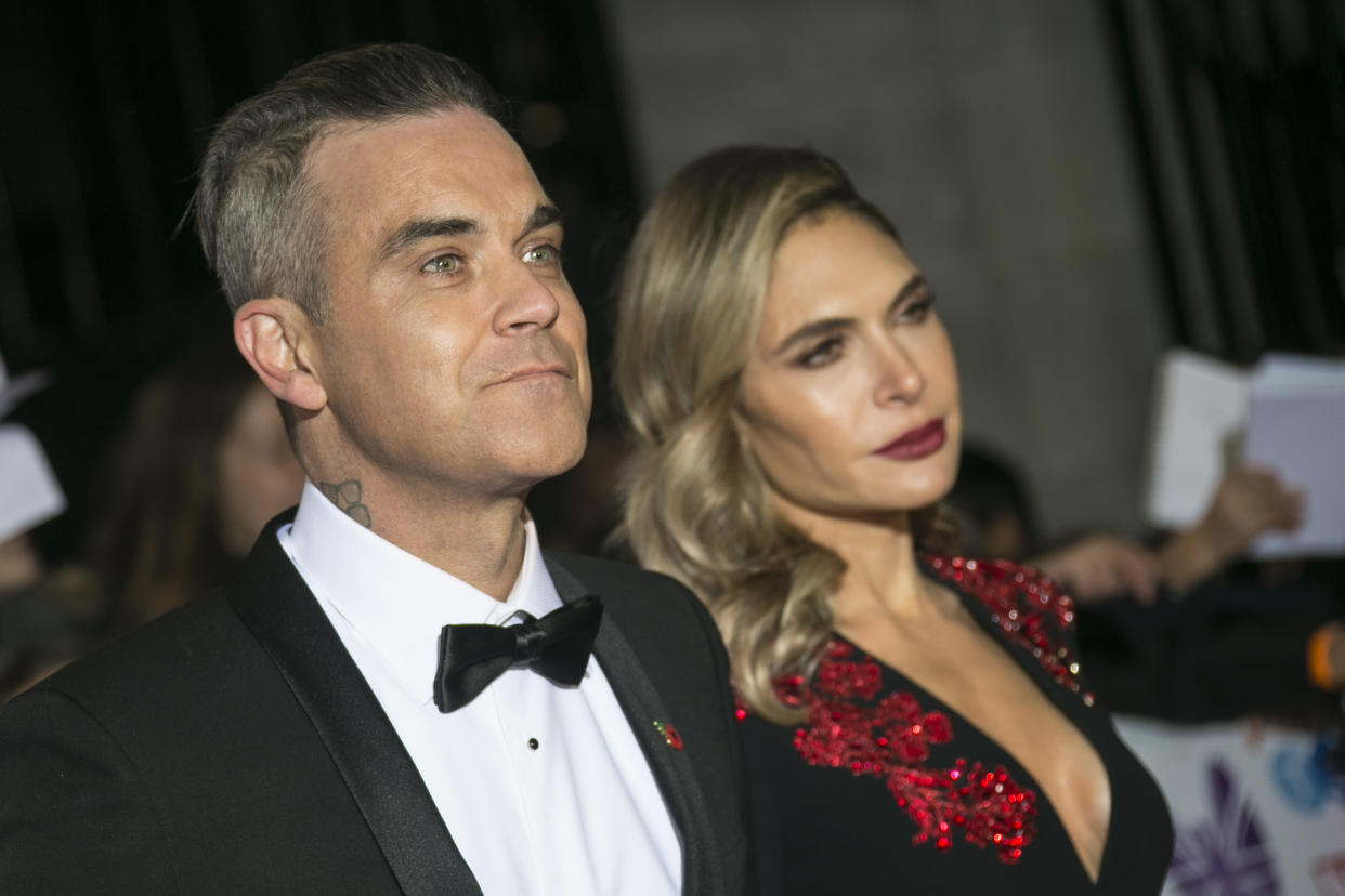 Singer Robbie Williams, left, and his wife and Ayda Field posesfor photographers upon arrival for the Pride of Britain Awards at a central London hotel, Monday, Oct. 29, 2018. (Photo by Joel C Ryan/Invision/AP)