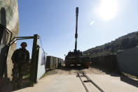 A South Korean marine stands next a K-9 self-propelled artillery during their regular drill on Yeonpyeong Island, South Korea Thursday, Nov. 1, 2018. The U.S. and South Korea are reviewing whether they will conduct large-scale military exercises next year and will decide before December. South Korean Defense Minister Jeong Kyeong-doo told reporters Wednesday at the Pentagon that if more exercises are suspended the two countries will conduct other training to mitigate the lapse. He says the review will be done by Nov. 15. (Jeon Heon-kyun/Pool Photo via AP)