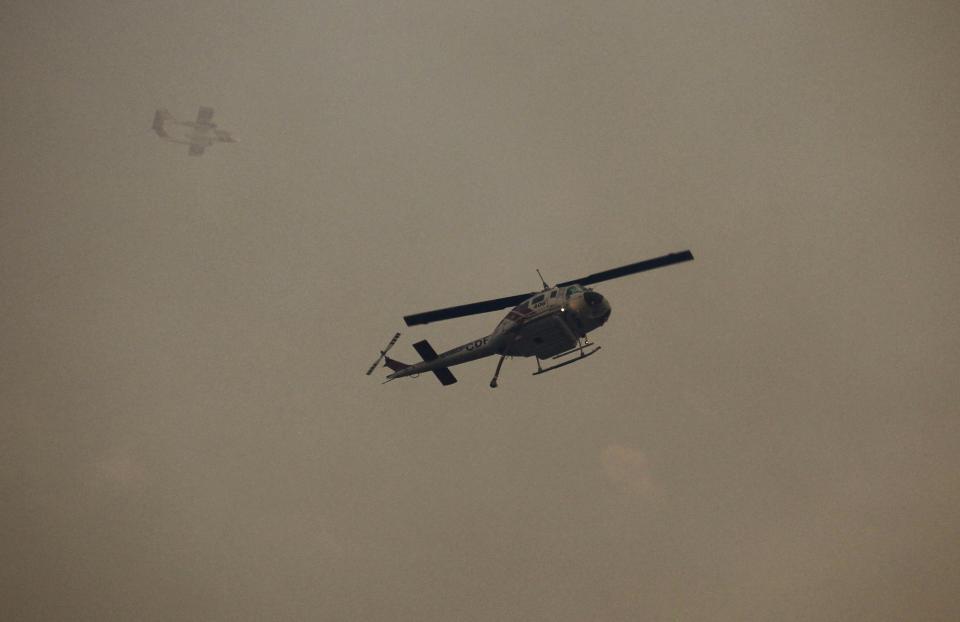 California Department of Forestry aircraft fly over a wildfire in Big Sur, California