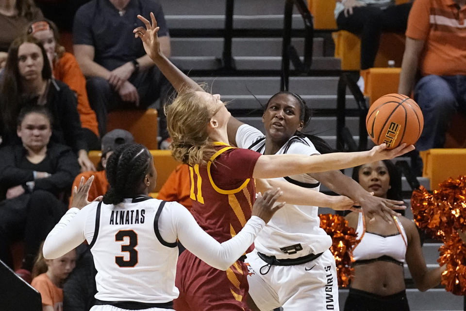 Iowa State guard Emily Ryan (11) is fouled by Oklahoma State forward Taylen Collins, right, as she shoots between Collins and guard Naomie Alnatas (3) in the second half of an NCAA college basketball game, Wednesday, Feb. 22, 2023, in Stillwater, Okla. (AP Photo/Sue Ogrocki)